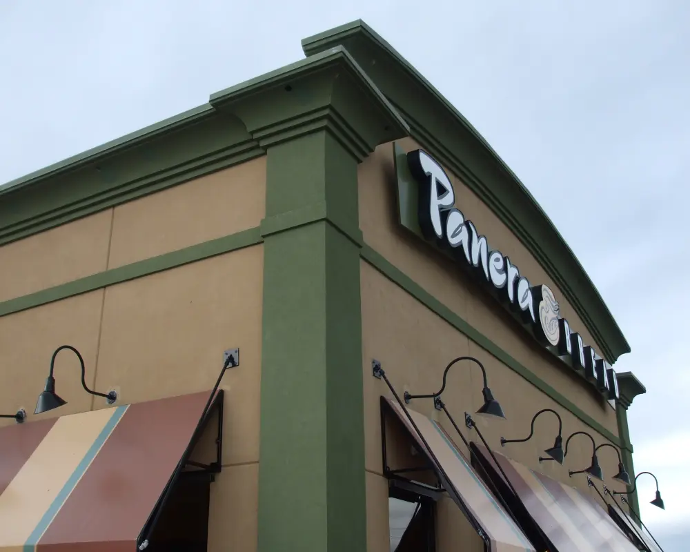 A panera bread restaurant with green commercial construction