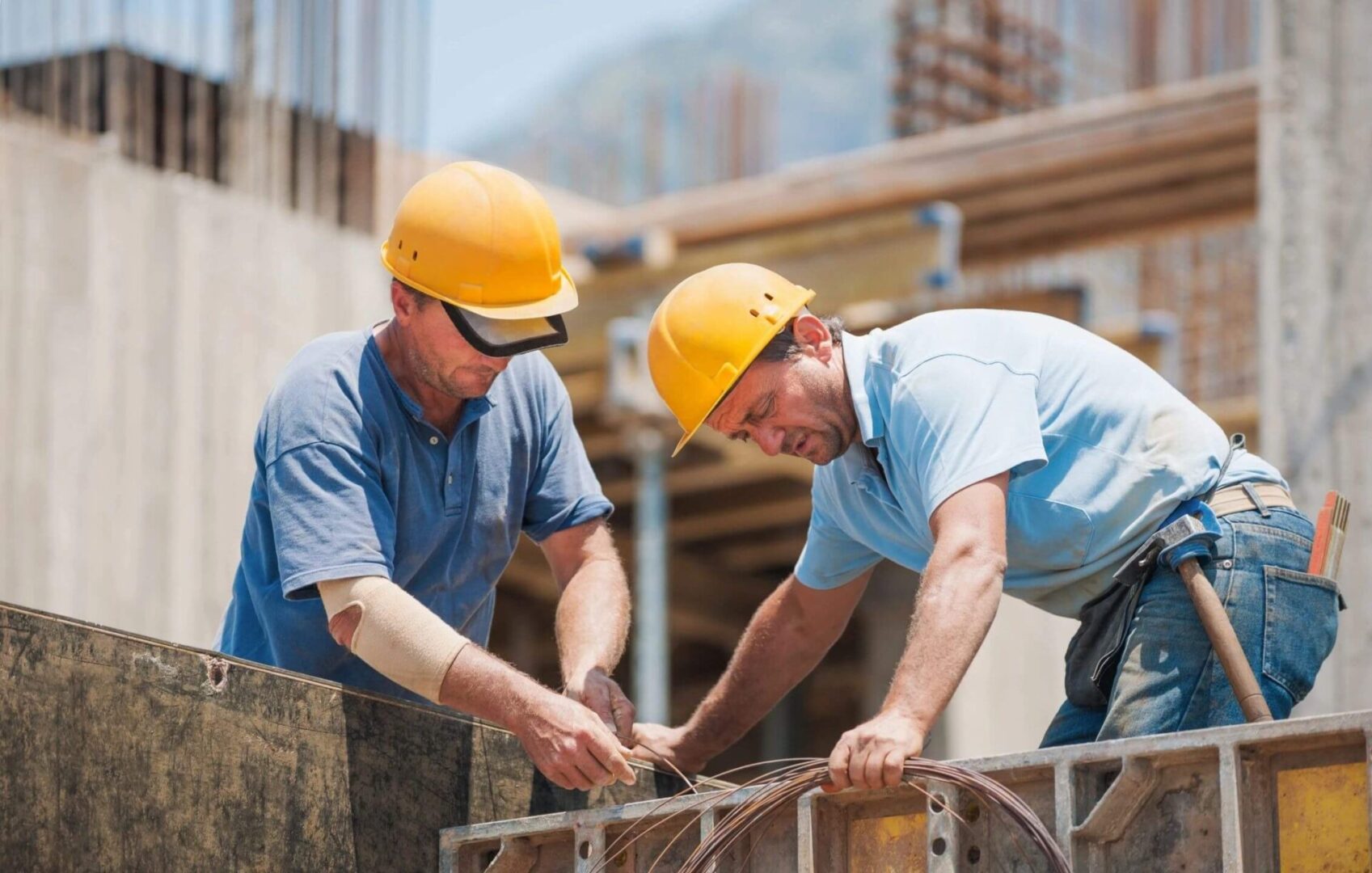 Two men in hard hats working architectural commercial contracting florida